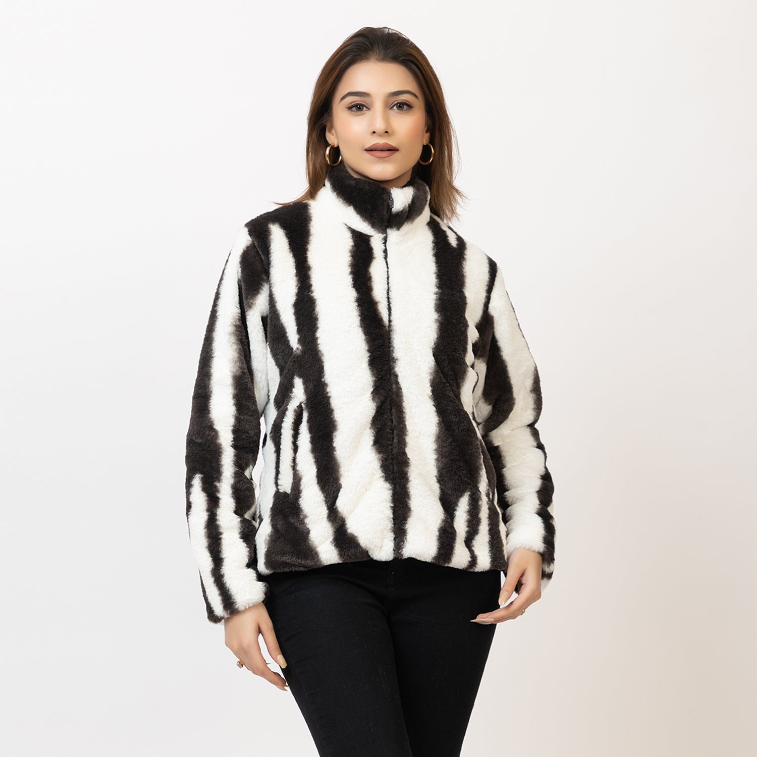 Woman wearing a black and white striped sweater on a plain background Amoldo