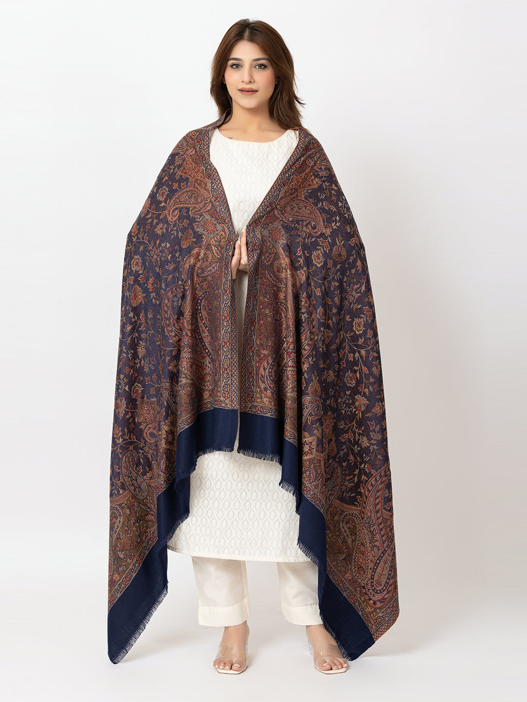  Amoldo Woman wearing a patterned shawl over a white outfit on a white background