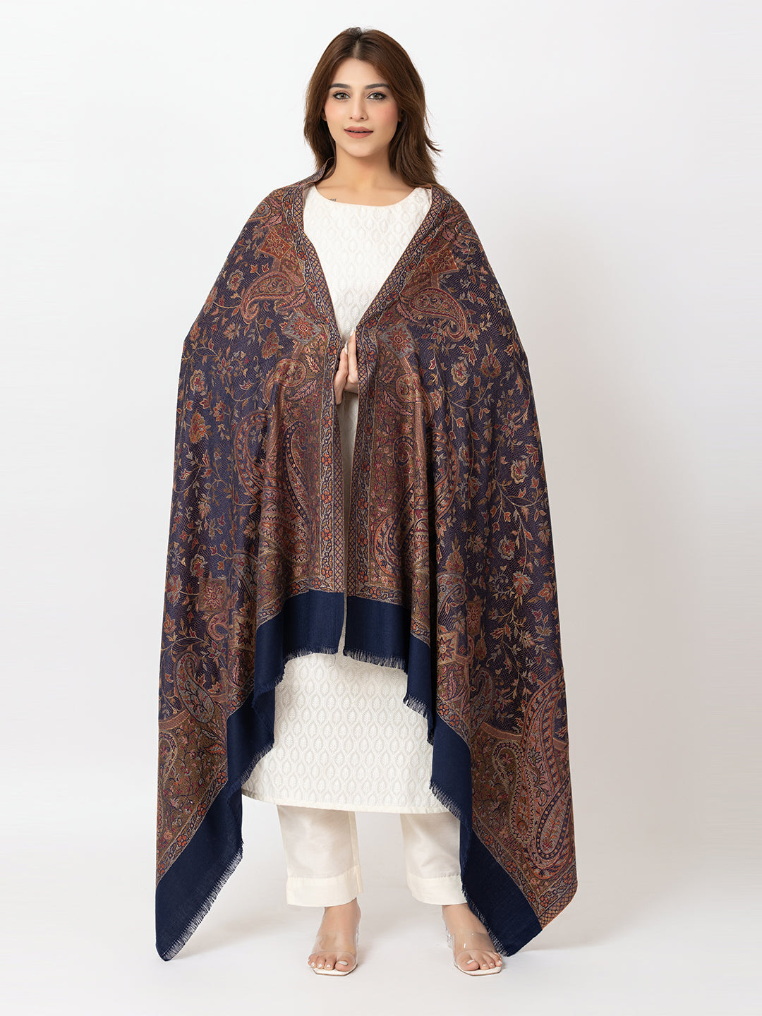  Amoldo Woman wearing a patterned shawl over a white outfit on a white background