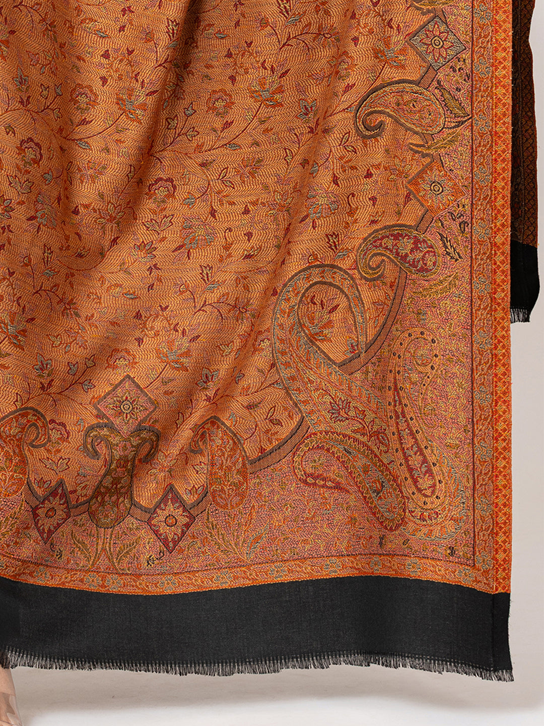  Amoldo Ornate orange and black patterned fabric with intricate designs on a white background