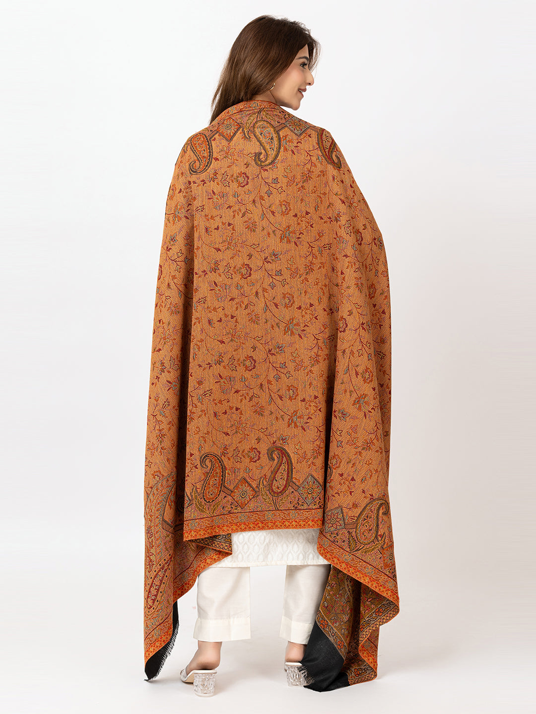   Amoldo Woman wearing a patterned orange shawl on a white background