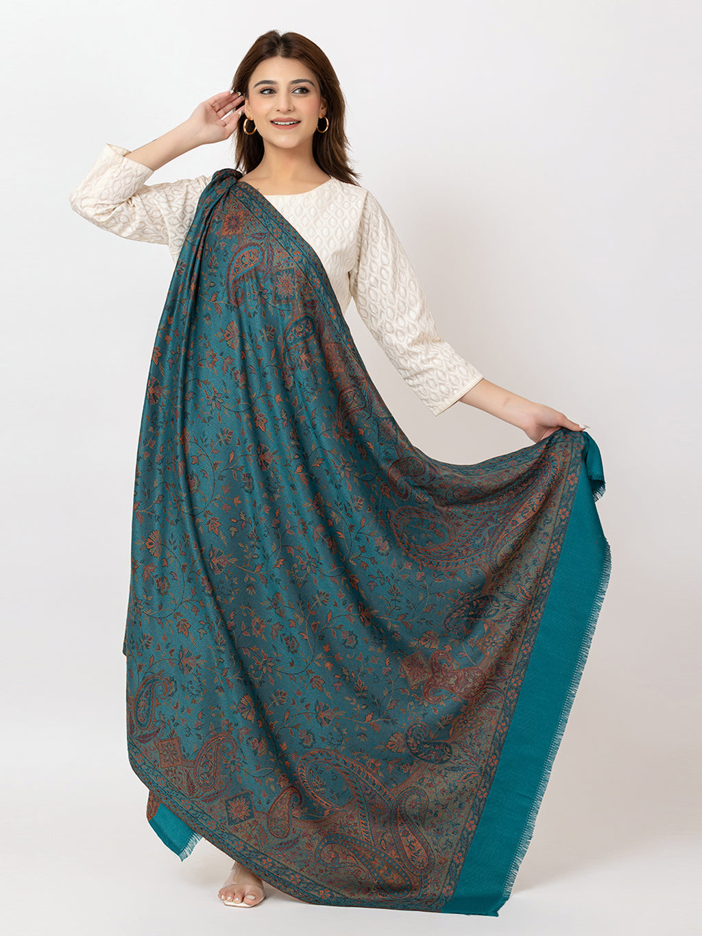  Amoldo  Woman holding a large teal and brown patterned scarf on a white background