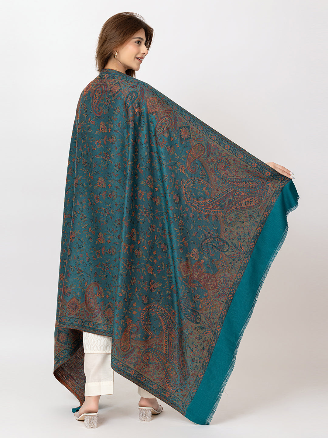  Amoldo  Woman wearing a teal and brown patterned shawl on a white background