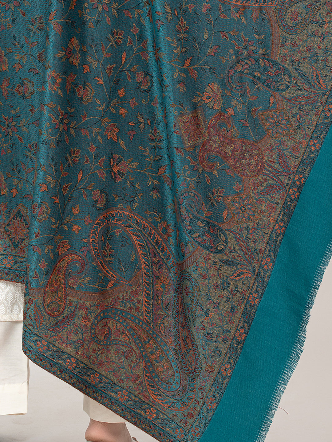   Amoldo  Teal and brown paisley patterned fabric draped over a surface